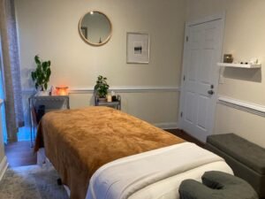 massage bed in a room with door and a mirror and plants