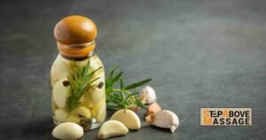 Lemongrass essential oils in a bottle with fresh lemongrass stalks